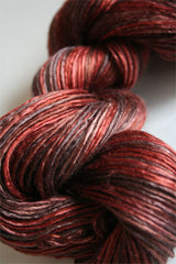 Close-up of Artyarns Silk Essence Lace silk yarn in a soft, shiny fiber with a delicate lace texture.