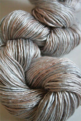 Soft silk yarn in a delicate lace weight from Artyarns Silk Essence Lace collection, showcasing its fine, smooth texture.