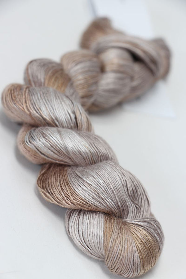 Soft silk yarn from Artyarns Silk Essence Lace collection, showcasing delicate, luxurious silk fibers in a natural fiber bundle.