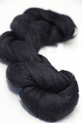 Soft, luxurious silk yarn from Artyarns Silk Essence Lace in a delicate lace pattern, showcasing its smooth texture and elegant sheen.