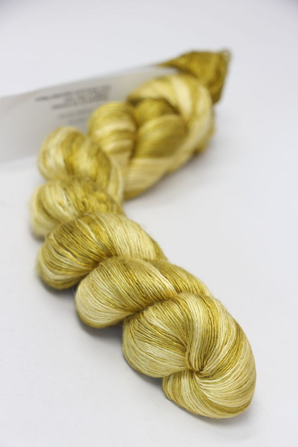 Soft, luxurious silk yarn from Artyarns Silk Essence Lace collection, showcasing delicate, smooth silk fibers in a neutral tone.