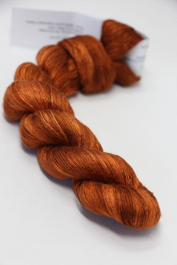 Soft pink Artyarns Silk Essence Lace silk yarn skein with delicate sheen and fine texture for luxurious knitting or crochet projects.