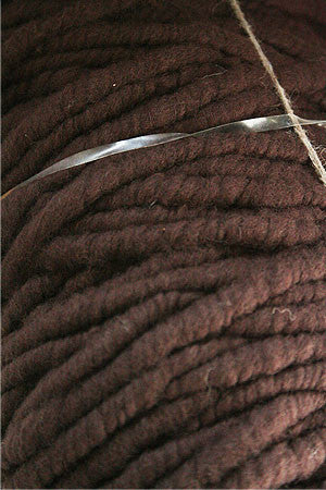 Close-up of Bagmith Merino Wool Bumps in chocolate color, showing soft, textured merino wool fabric with small, rounded bumps.