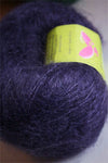 Be Sweet medium brushed mohair yarn in indigo color, showcasing soft, textured fibers ideal for knitting and crochet projects.