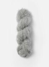 Blue Sky Fibers Brushed Suri alpaca yarn in soft blue color, showing the fluffy, textured skein with a gentle sheen.