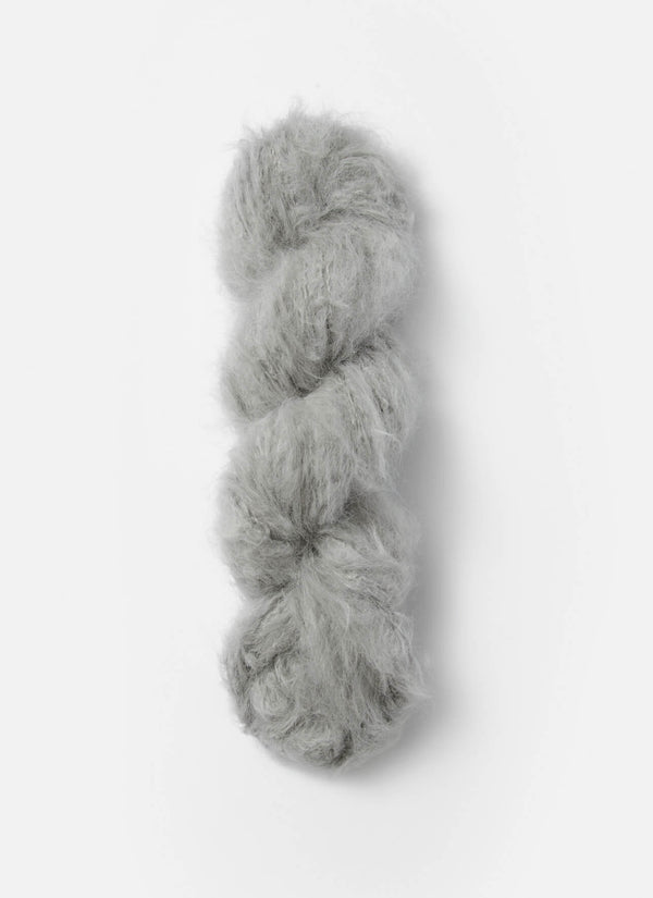 Blue Sky Fibers Brushed Suri alpaca yarn in soft blue color, showing the fluffy, textured skein with a gentle sheen.