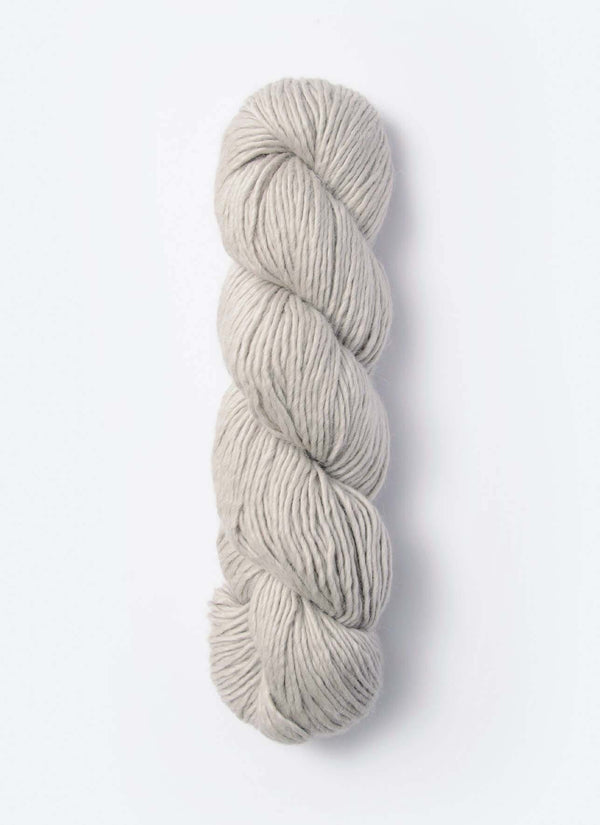 Blue Sky Fibers Suri Merino alpaca and merino yarn in soft blue, showcasing its smooth, fluffy texture and vibrant color.