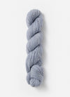 Blue Sky Fibers Baby Alpaca Sport Weight yarn in Melange 800 Series, showing soft, variegated blue and gray alpaca yarn skein