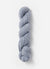 Blue Sky Fibers Baby Alpaca Sport Weight yarn in Melange 800 Series, showing soft, variegated blue and gray alpaca yarn skein