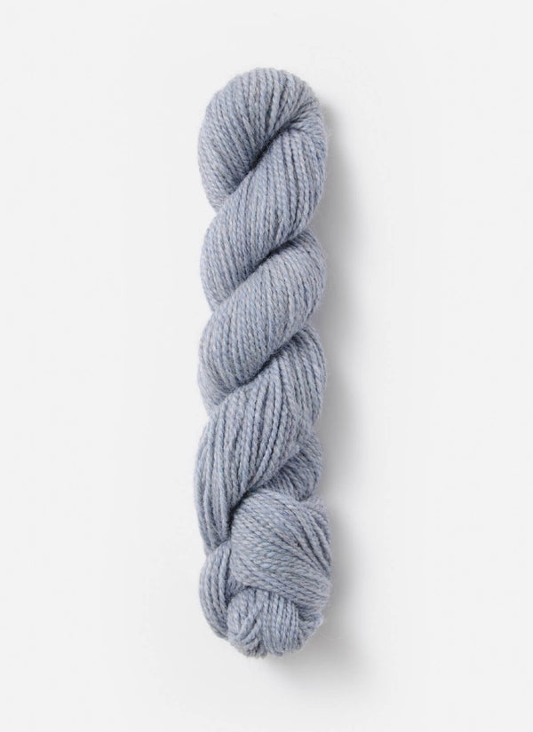 Blue Sky Fibers Baby Alpaca Sport Weight yarn in Melange 800 Series, showing soft, variegated blue and gray alpaca yarn skein