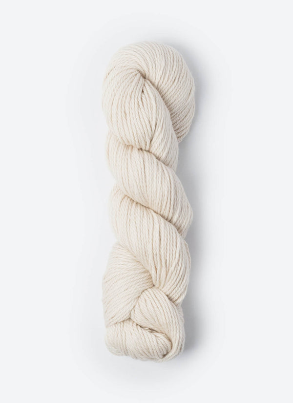 Blue Sky Fibers Sweater Worsted Superwash knitting yarn in blue, showing soft wool and cotton blend fibers for cozy knitting projects.