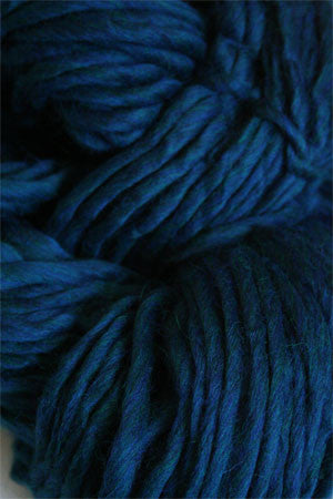 Cascade Yarns Magnum bulky yarn in vibrant red, showcasing thick, soft fibers suitable for cozy knitting projects.