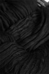 Black Cascade Yarns Magnum bulky yarn ball, soft and thick for cozy knitting or crochet projects.
