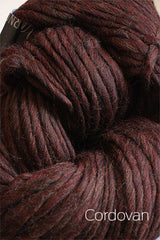 Cascade Yarns Magnum bulky yarn in a rich cordovan color, showcasing thick, soft wool fibers ideal for warm knitting projects.
