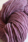 Cascade Yarns Magnum bulky yarn in a soft mulberry flurry color, shown in a close-up of the textured fiber strands.