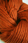 Cascade Yarns Magnum bulky yarn in pumpkin orange, showcasing thick, soft yarn ideal for cozy knitting projects.