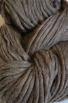 Cascade Yarns Magnum bulky yarn in walnut heather color, showcasing thick, soft yarn strands ideal for cozy knitting projects.