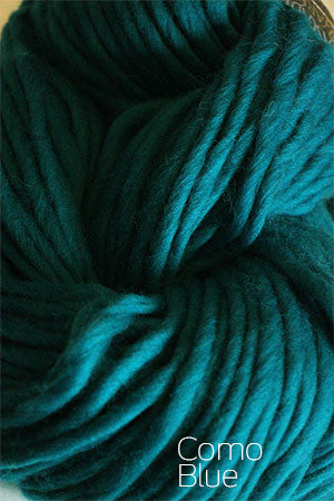 Cascade Yarns Magnum bulky yarn in vibrant multicolor skein, showcasing thick, soft wool for cozy knitting projects.