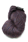 Brightly colored Cascade Yarns Magnum bulky yarn ball with a galaxy-inspired pattern, showcasing vibrant purple, pink, and blue hues.