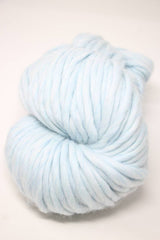 Cascade Yarns Magnum bulky yarn in vibrant blue color, shown in a close-up of the soft, thick fiber texture.