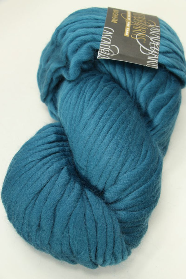 Close-up of Cascade Yarns Magnum bulky yarn in a neutral color, showcasing its thick, soft texture suitable for warm knitting projects.