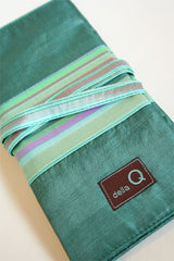 Della Q interchangeable needle case in seafoam with compartments for knitting needles and accessories.
