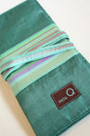 Della Q interchangeable needle case in seafoam with compartments for knitting needles and accessories.