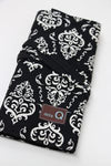 Della Q interchangeable needle case in Columbia pattern holding multiple sewing needles and tools for knitting and crochet.