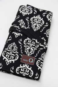 Della Q interchangeable needle case in Columbia pattern holding multiple sewing needles and tools for knitting and crochet.