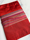 Red striped Della Q double point knitting needle case with organized slots for knitting needles and accessories.