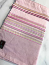 Della Q double point knitting needle case in pink and white stripes, designed to organize and protect knitting needles.