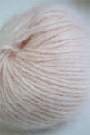 Soft Belangor French Angora yarn by Galler Yarn, showing delicate, fluffy fibers in a natural off-white color.