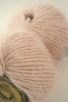 Galler Yarn Belangor French Angora yarn in natural cream color, soft and fluffy angora fiber close-up shot.