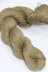 Golden-colored Jade Sapphire Sylph linen and cashmere yarn skein, soft and luxurious for knitting or crochet projects.
