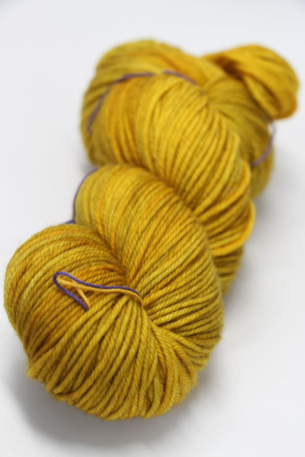 Madelinetosh Tosh DK yarn in Candlewick color, soft and versatile wool blend suitable for knitting and crochet projects.