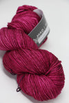 Madelinetosh Tosh DK yarn in Coquette Deux, showing soft pink and purple tones with a smooth, twisted skein.