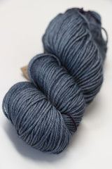 Madelinetosh Tosh DK yarn in a deep rust color, soft and thick-dyed wool for knitting and crochet projects.