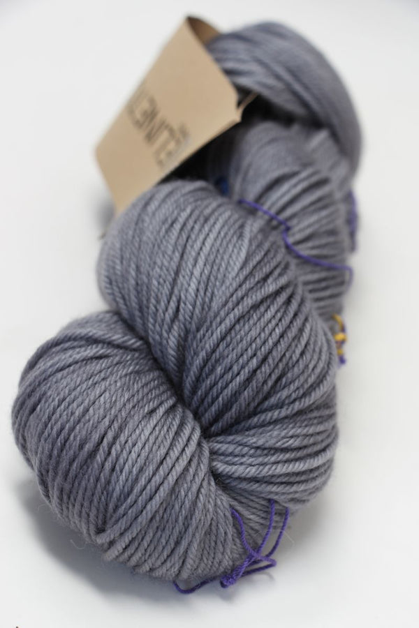 Light grey and owl-colored Madelinetosh Tosh DK yarn skein showcasing soft, dyed wool in a close-up shot.