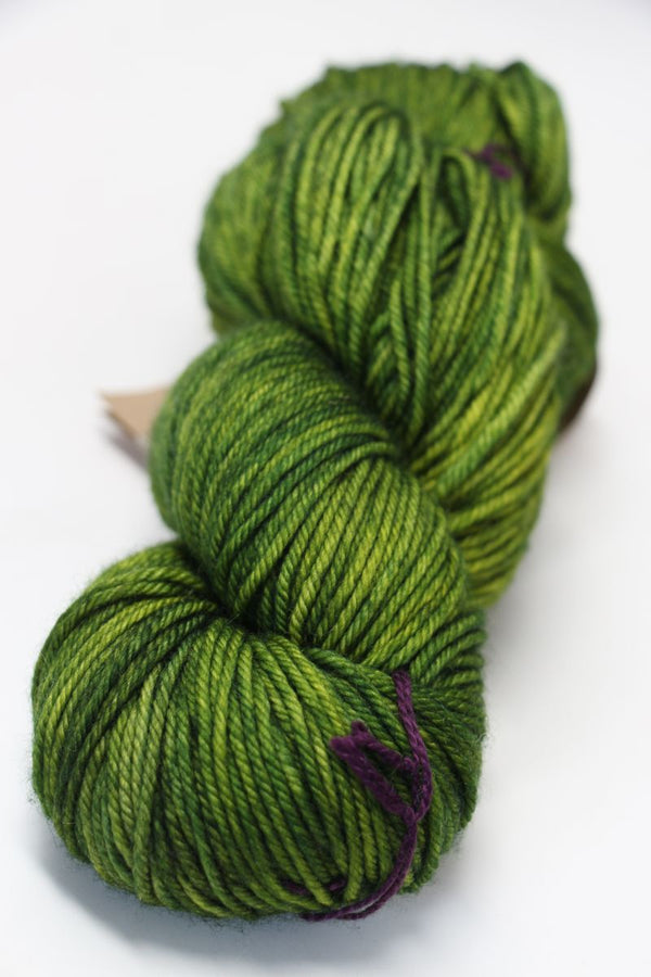 MadelineTosh Tosh DK yarn in Jade color, soft wool skein for knitting and crocheting projects, with vibrant green and blue tones.