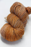 Madelinetosh Tosh DK yarn in Brick Dust color, showcasing soft, twisted wool fibers perfect for knitting or crochet projects.