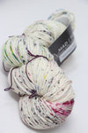 Madelinetosh Tosh DK yarn in a rich, earthy colorway, showing a close-up of the soft, twisted wool fiber suitable for knitting and crochet.