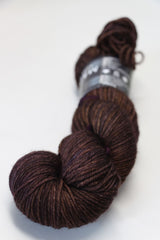 Soft, colorful Madelinetosh Tosh DK yarn in a vibrant fig colorway, showcased in a close-up image highlighting its texture and rich hue.