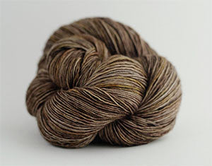 Madelinetosh Tosh DK yarn in Woodstock colorway, showcasing a soft, hand-dyed wool yarn with rich, warm tones.