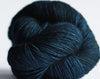 Madelinetosh Tosh DK yarn in deep color, showing soft wool texture and vibrant dye, ideal for knitting and crochet projects.