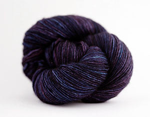 Madelinetosh Tosh DK yarn in Raspberry Cordial, soft and vibrant hand-dyed wool skein for knitting and crochet projects.