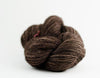 Madelinetosh Tosh DK yarn in pecan hull color, showcasing soft, textured wool yarn with subtle color variations.