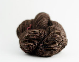 Madelinetosh Tosh DK yarn in pecan hull color, showcasing soft, textured wool yarn with subtle color variations.