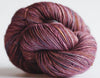 Close-up of Madelinetosh Tosh DK yarn in vibrant kilim colorway, showing soft, twisted wool fibers suitable for knitting and crochet projects.
