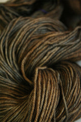 Madelinetosh Tosh DK yarn in Badlands colorway, soft and vibrant wool-dk weight for knitting and crochet projects.