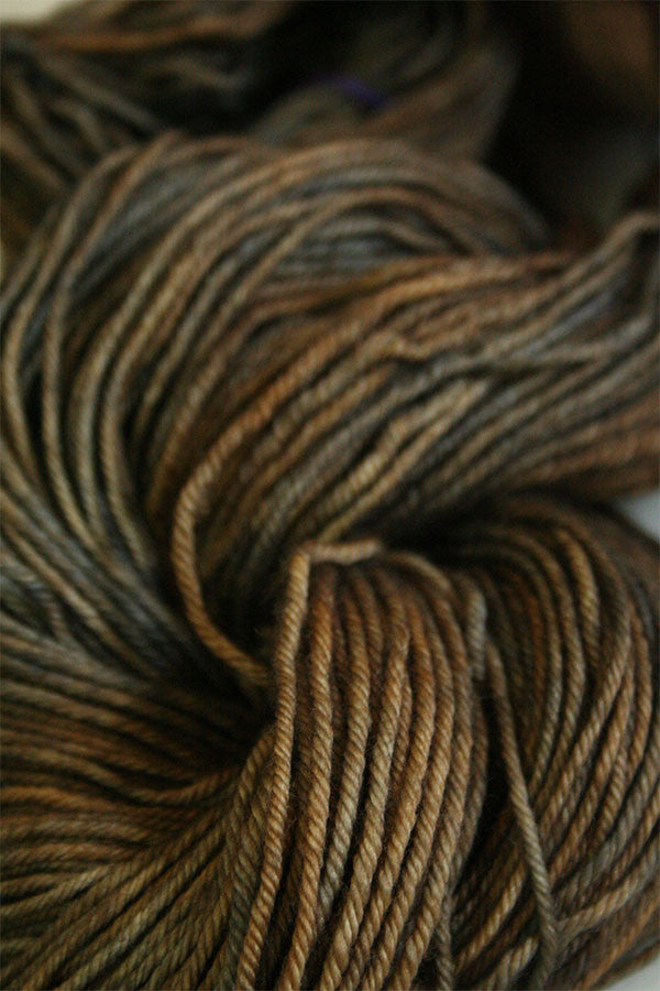 Madelinetosh Tosh DK yarn in Badlands colorway, soft and vibrant wool-dk weight for knitting and crochet projects.